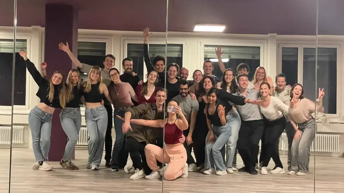 Dancers laughing together while learning Bachata at a social dance class in Zurich
