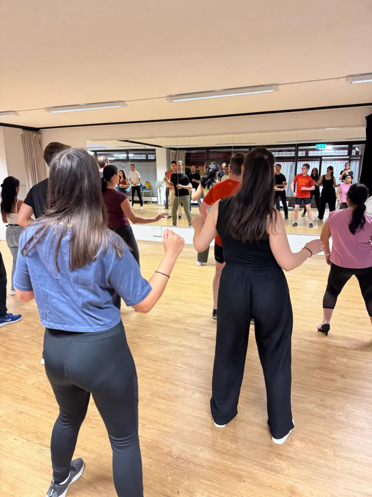 Students learning new partnerwork moves in class